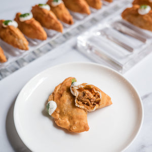 Open image in slideshow, Fried appetizers on a white plate with a marble background
