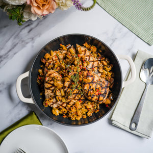 Open image in slideshow, Dish of grilled chicken on a marble table with flowers and cutlery
